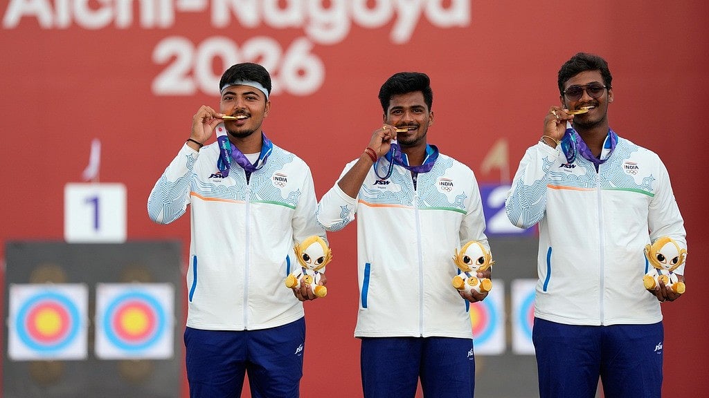 India's Sahil Rajesh Jadhav, center, Kushal Dalal, left, and Ganesh Mani Ratnam Thirumuru, right, pose with the gold medals on the podium after the compound men's team final in archery at the Asian Games in Okazaki, Japa. - PTI