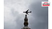 From Pakistan To Xinjiang: India’s Search For A New Air Route Reuters : A plane flies past a monumemt with the rain clouds in the background, during the monsoon season in Karachi