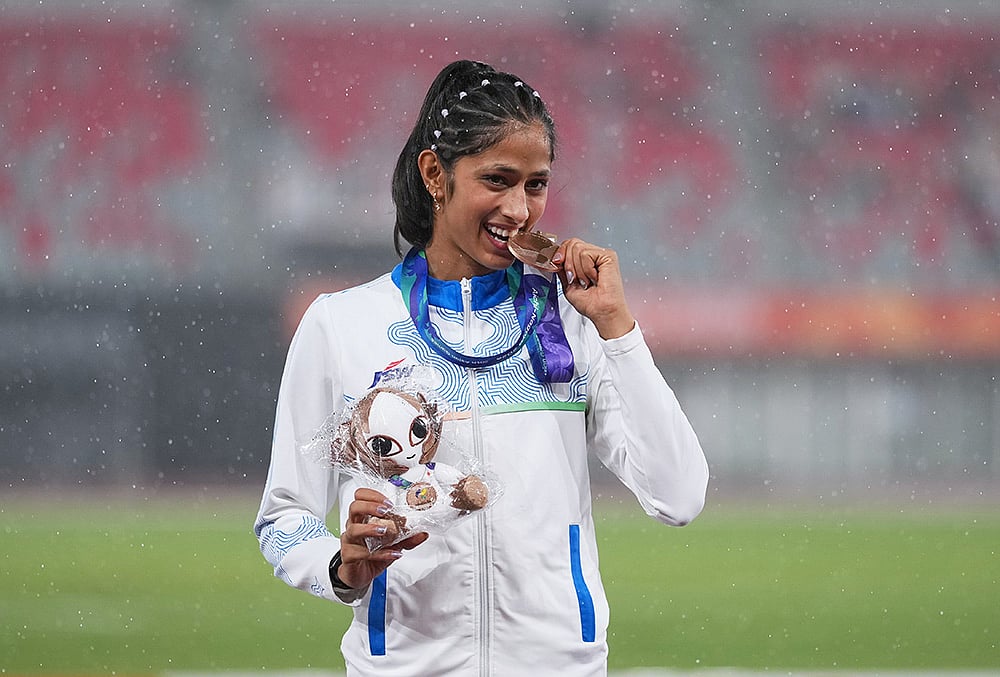 Bronze medalist Pooja of India poses on the podium following the women's high jump final at the Asian Games in Nagoya, Japan, Tuesday, Sept. 29, 2026.  - | Photo: AP/Lee Jin-man
