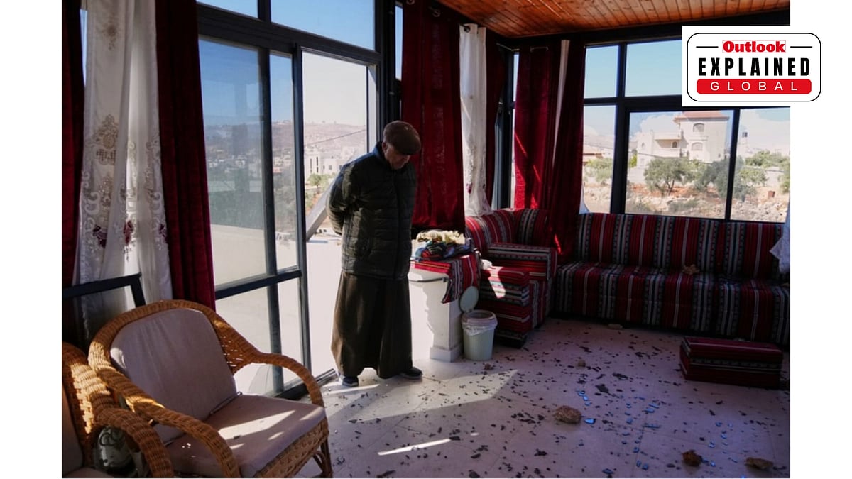 Mustafa Zaatar, a Palestinian American, looks at the damage to his family home following an attack by Israeli settlers in the Palestinian village of Abu Falah, West Bank - AP Photo/Mahmoud Illean