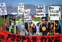 OpenAI DevDay 2026: Protesters Rally Outside Conference In San Francisco | Photo: AP/Josh Edelson : AI protesters chant in front of the Golden Gate Bridge during the OpenAI DevDay 2026 conference in San Francisco, California, Tuesday, Sept. 29, 2026.