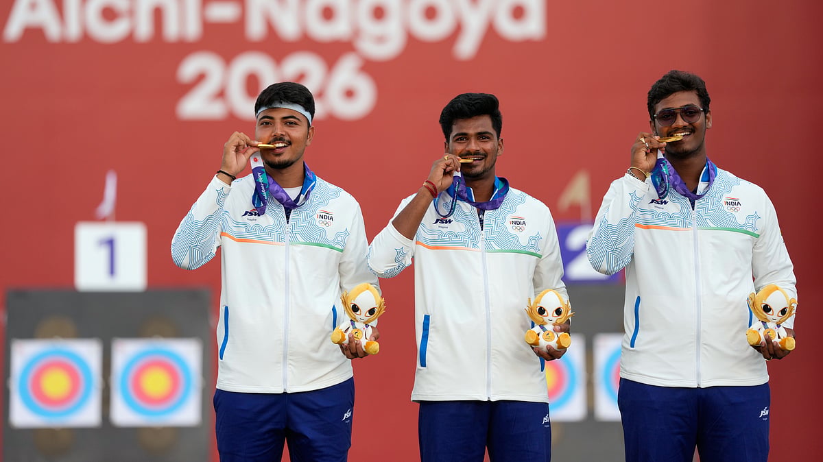 India's Sahil Rajesh Jadhav, center, Kushal Dalal, left, and Ganesh Mani Ratnam Thirumuru, right, pose with the gold medals on the podium after the compound men's team final in archery at the Asian Games in Okazaki, Japan, Wednesday, Sept. 30, 2026. - (AP Photo/Eugene Hoshiko)