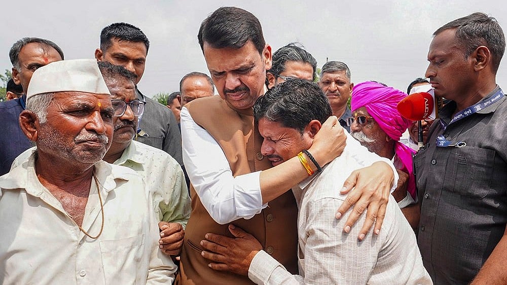 Maharashtra CM Devendra Fadnavis meets people affected by the drought-like situation in Jau, Nilanga taluka, Latur district.  - | Photo: @CMOMaharashtra/X via PTI 