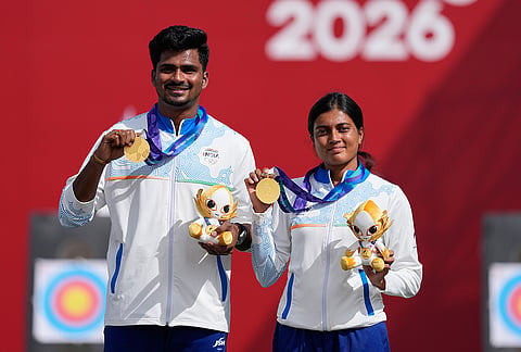 Gold medalists, India's Sahil Rajesh Jadhav, left, and Chikitha Taniparthi, right, celebrate on the podium after winning the compound mixed team final in archery at the Asian Games in Okazaki, Japan, Wednesday, Sept. 30, 2026. 
