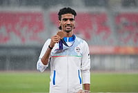 | Photo: AP/Lee Jin-man : Bronze medalist Gulveer Singh of India poses on the podium following the men's 5000-meter final at the Asian Games in Nagoya, Japan, Tuesday, Sept. 29, 2026. 
