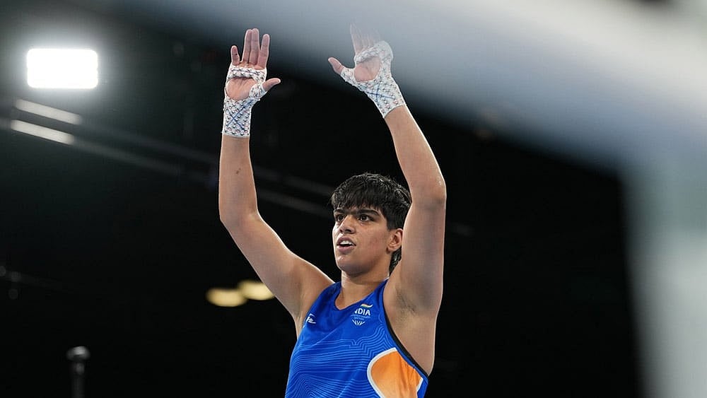 India's Priya Ghanghas celebrates after winning the women's 60kg boxing final at the Commonwealth Games in Glasgow, Scotland. - | Photo: AP/Eranga Jayawardena