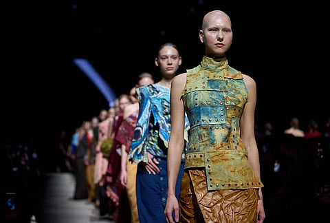 Models wear a creations by students of the Russian Institute of Business and Design B&D on a runway at the Moscow Fashion Week in Moscow.