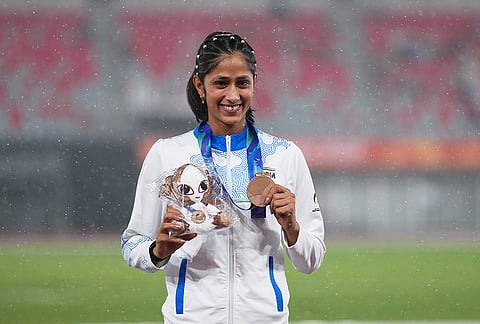 Bronze medalist Pooja of India poses on the podium following the women's high jump final at the Asian Games in Nagoya, Japan, Tuesday, Sept. 29, 2026. 