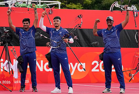 India's Sahil Rajesh Jadhav, left, Kushal Dalal, center, and Ganesh Mani Ratnam Thirumuru, right, celebrate after winning over China during the compound men's team final in archery at the Asian Games in Okazaki, Japan, Wednesday, Sept. 30, 2026.
