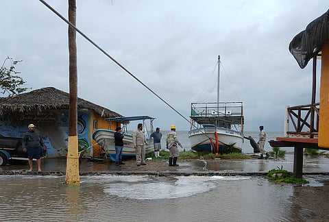 Workers pull a boat to shore as Hurricane Polo approaches Puerto San Carlos, Baja California Sur state, Mexico, Monday, Sept. 28, 2026. 
