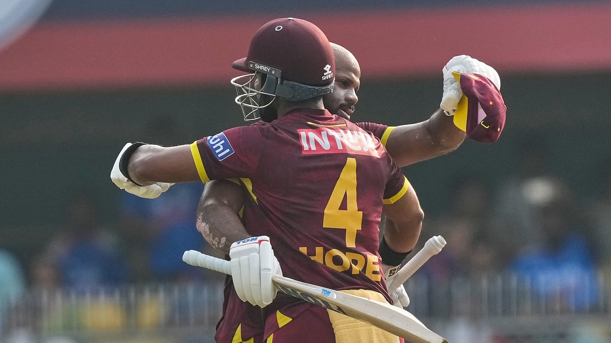 West Indies' John Campbell celebrates his century with his batting partner Shai Hope during the second one-day international cricket match between India and West Indies in Guwahati, India, Wednesday, Sept. 30, 2026. - (AP Photo/ Anupam Nath)
