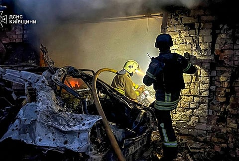 In this photo provided by the Ukrainian Emergency Services on Wednesday, Sept. 30, 2026, rescuers put out a fire in a garage destroyed after a Russian drone strike on Kyiv region, Ukraine. 