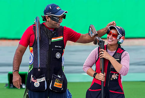 India's Neeru Dhanda, right, and Kynan Chenai celebrate after winning gold medal in the trap mixed team shooting event during the 20th Asian Games, in Nagoya, Japan, Wednesday, Sept. 30, 2026.