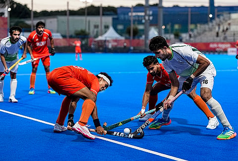 India's Shilanand Lakra, 99, and Abhishek, 5, vie for the ball with Pakistan's Ammad Butt, 16, during a men's semifinal hockey match between India and Pakistan, at the ongoing 20th Asian Games, in Kakamigahara, Japan, Thursday, Oct. 1, 2026. 