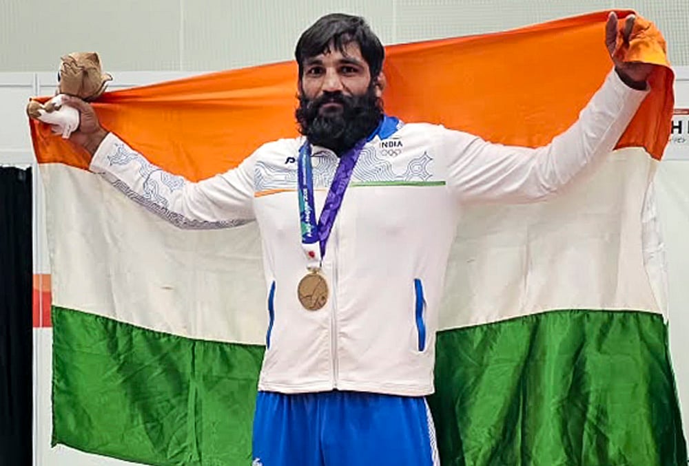 Indian wrestler Sunil Kumar celebrates after winning the bronze medal in the men's 87kg Greco-Roman wrestling event at the Asian Games 2026, in Nagoya, Japan. Kumar defeated Philippines' Roberts Callum Johnston 9-0 to become the first Indian wrestler to secure two Asian Games medals in Greco-Roman wrestling.  - | Photo: Handout via PTI 