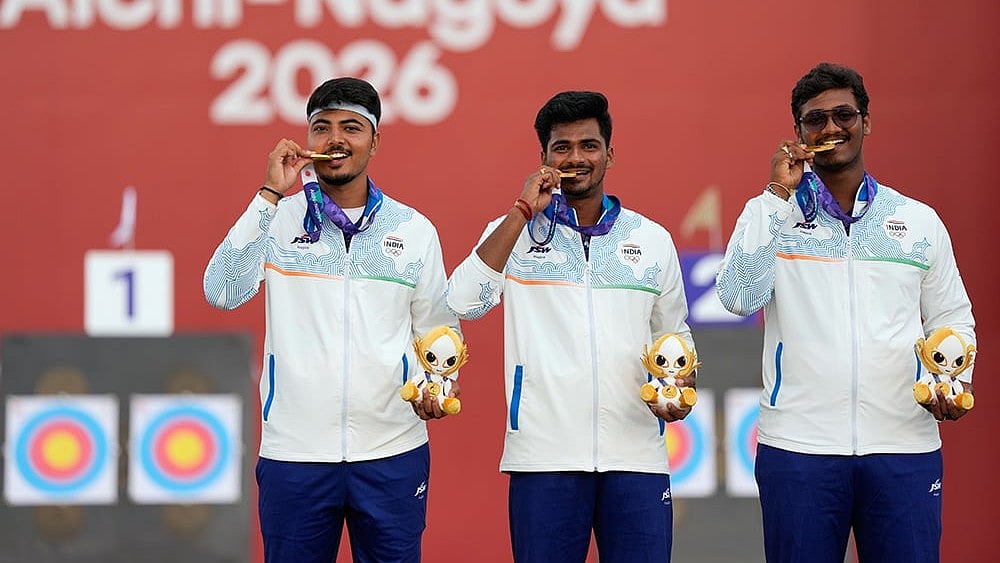 India's Sahil Rajesh Jadhav, center, Kushal Dalal, left, and Ganesh Mani Ratnam Thirumuru, right, pose with the gold medals on the podium after the compound men's team final in archery at the Asian Games in Okazaki, Japan, Wednesday, Sept. 30, 2026. - | Photo: AP/Eugene Hoshiko