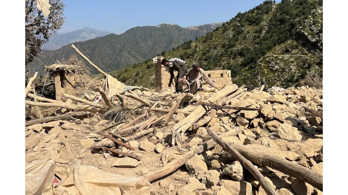 Men salvage their belongings from the debris of a house that was damaged in what the Taliban said was a Pakistani airstrike in Shultan district in Kunar province - Afghanistan
