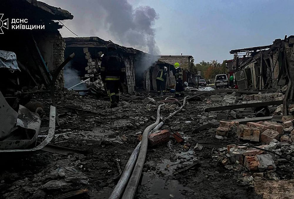 Rescuers put out a fire affecting garages destroyed after a Russian drone strike on Kyiv region, Ukraine.  - | Photo: Ukrainian Emergency Service via AP