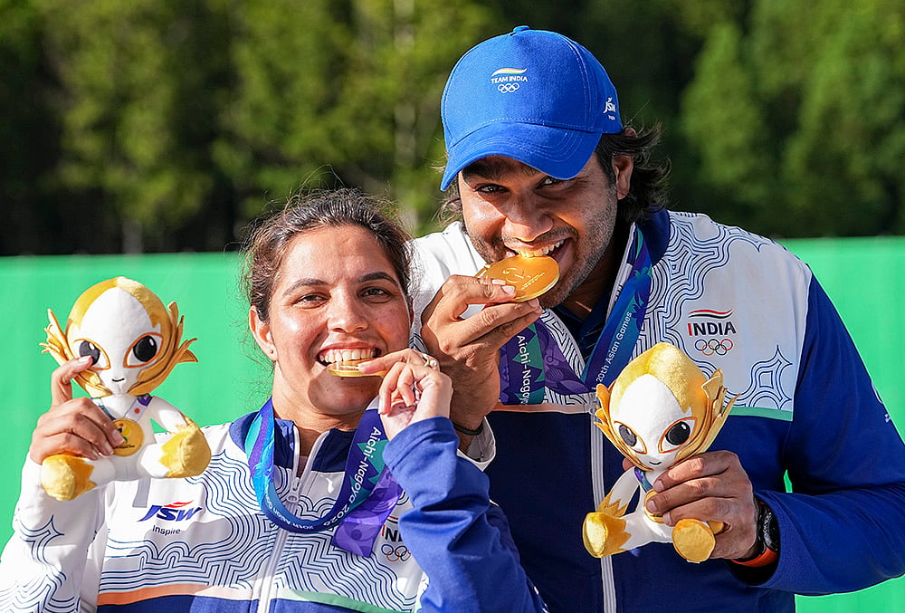 Gold medallist India's Neeru Dhanda, left, and Kynan Chenai pose for photographers during the medal ceremony after the trap mixed team shooting event at the 20th Asian Games, in Nagoya, Japan. - | Photo: PTI/Atul Yadav
