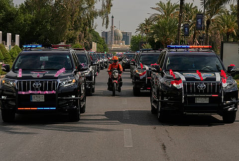 Iraqi security vehicles decorated with national flags and ribbons drive in a convoy as they celebrate the complete withdrawal of U.S. troops from Iraq, in Baghdad, Iraq, Wednesday, Sept. 30, 2026. 
