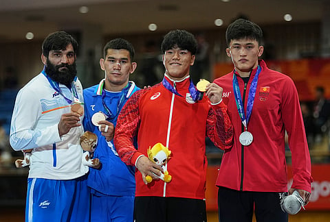 From left, bronze medalists India's Sunil Kumar and Uzbekistan's Jalgasbay Berdimuratov, gold medalist Japan's Taizo Yoshida, silver medalist Kyrgyzstan's Asan Kurbanovich Zhanyshov pose for a photograph during the awards ceremony at in the men's greco-roman 87kg wrestling match the Asian Games in Nagoya, Japan, Wednesday, Sept. 30, 2026. 