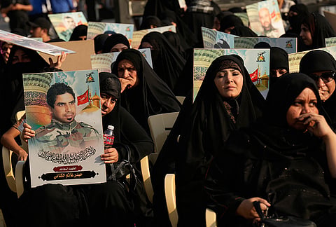 Women hold portraits of slain Iraqi fighters during celebrations marking the complete withdrawal of U.S. troops from Iraq, in Baghdad, Iraq, Wednesday, Sept. 30, 2026. 