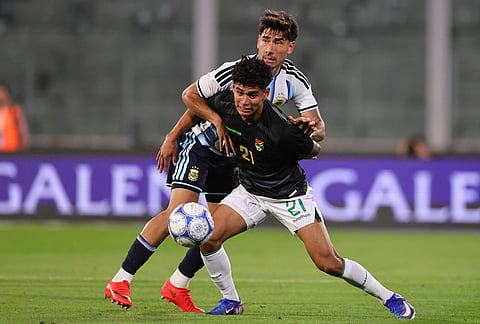Argentina's Roman Vega, left, and Bolivia's Yomar Rocha battle for the ball during an international friendly soccer match in Cordoba, Argentina, Wednesday, Sept. 30, 2026. 