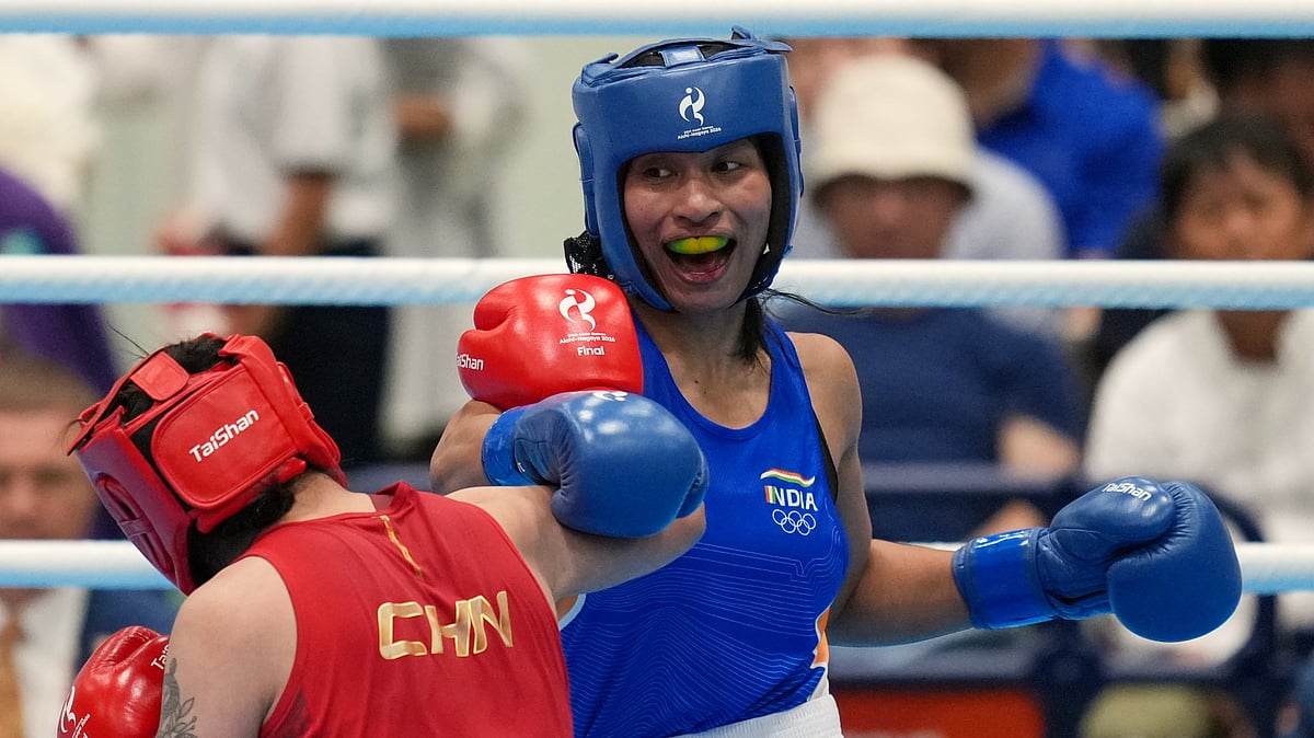 India's Lovlina Borgohain, in blue, and China's Bao Ziyi, in red, fight in their women's 75kg boxing final match at the Asian Games in Nishio, Aichi prefecture, Japan, Friday, Oct. 2, 2026. - (AP Photo/Lee Jin-man)