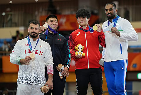 From left, Bronze medalists Iran's Mehdi Balihamzehdeh and Mongolia's Gankhuyag Ganbaatar, gold medalist Japan's Yuri Nakazato, silver medalist India's Nitesh pose for a photograph during the awards ceremony men's greco-roman 97kg final wrestling match at the Asian Games in Nagoya, Japan, Thursday, Oct. 1, 2026. 
