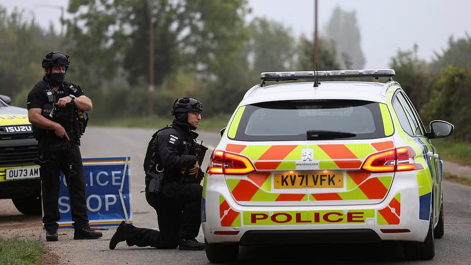 Police officers guard an area as roadblocks remain in place near RAF Fairford airbase - Reuters