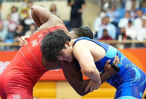 Japan's Yuri Nakazato, right, competes against India's Nitesh during the men's greco-roman 97kg final wrestling match at the Asian Games in Nagoya, Japan, Thursday, Oct. 1, 2026.