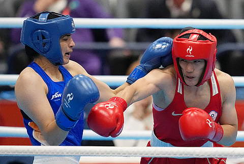India's Parveen, in blue, and Taiwan's Chen Nien-chin, in red, fight in their women's 65kg boxing final match at the Asian Games in Nishio, Aichi prefecture, Japan, Friday, Oct. 2, 2026.
