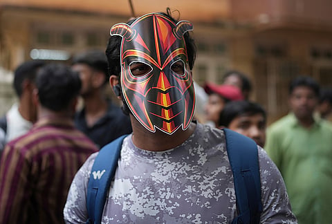 A supporter of the Cockroach Janta Party wears a mask as he arrives to take part in a protest against Chief Election Commissioner Gyanesh Kumar and call for the suspension of the Special Intensive Revision (SIR) of electoral rolls in Mumbai, Friday, Oct. 2, 2026. 

