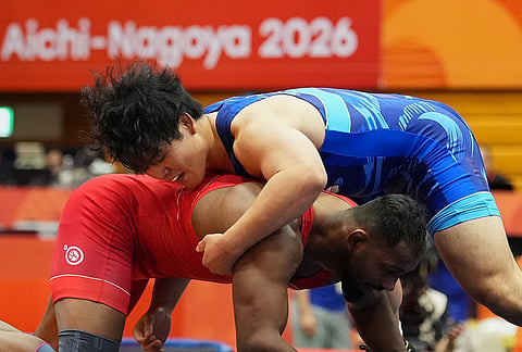Japan's Yuri Nakazato, top, competes against India's Nitesh during the men's greco-roman 97kg final wrestling match at the Asian Games in Nagoya, Japan, Thursday, Oct. 1, 2026. 

