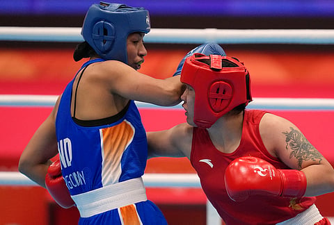 India's Lovlina Borgohain, in blue, and China's Bao Ziyi, in red, fight in their women's 75kg boxing final match at the Asian Games in Nishio, Aichi prefecture, Japan, Friday, Oct. 2, 2026. 