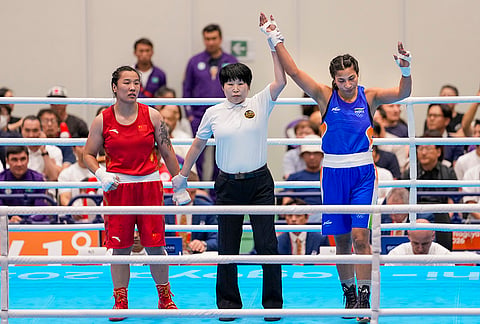 India's Lovlina Borgohain, in blue, celebrates after winning gold medal in the women's 75kg final boxing bout against China's Ziyi Bao at the 20th Asian Games, in Nishio, Aichi, Japan, Friday, Oct. 2, 2026. 