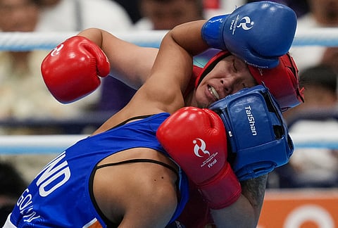 India's Lovlina Borgohain, in blue, and China's Bao Ziyi, in red, fight in their women's 75kg boxing final match at the Asian Games in Nishio, Aichi prefecture, Japan, Friday, Oct. 2, 2026. 
