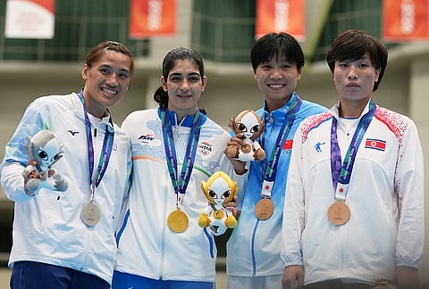 Gold medalist, India's Parveen, center, flanked by silver medalist Taiwan's Chen Nien-chin, left, and bronze medalists, North Korea's Hwang Hyo Sun, right, and China's Li Shu, second right, during the medal ceremony for the women's 65kg boxing event at the Asian Games in Nishio, Aichi prefecture, Japan, Friday, Oct. 2, 2026. 
