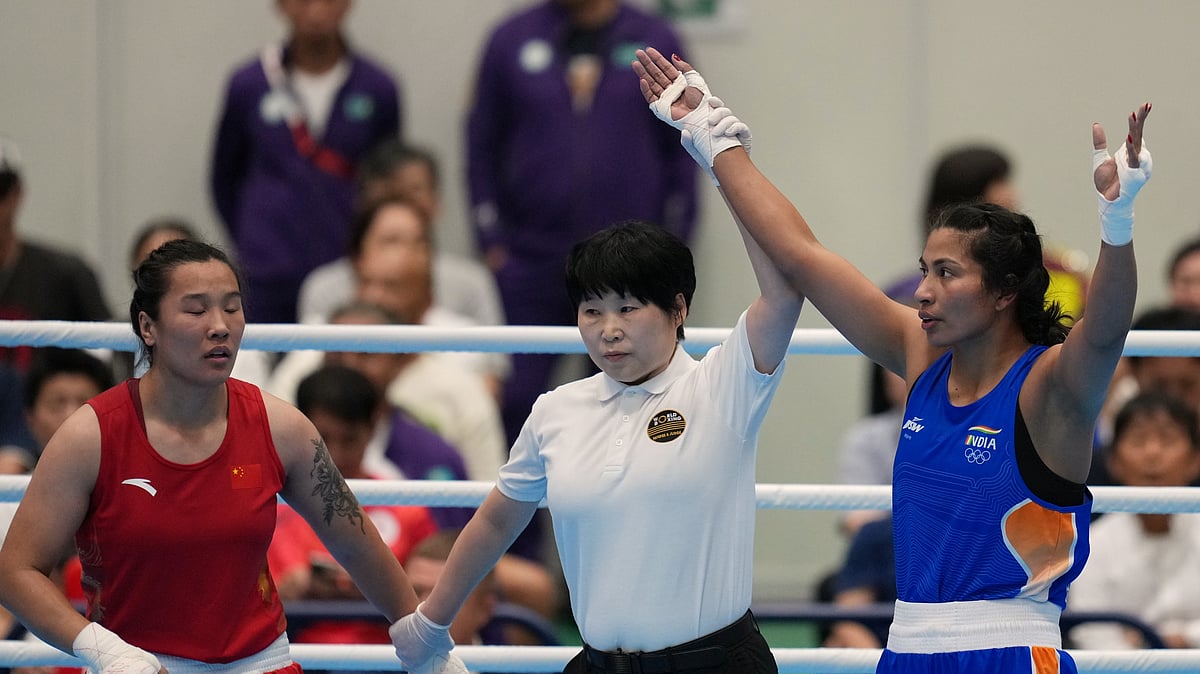 India's Lovlina Borgohain, in blue, celebrates after winning over China's Bao Ziyi, in red, in their women's 75kg boxing final match at the Asian Games in Nishio, Aichi prefecture, Japan, Friday, Oct. 2, 2026. - (AP Photo/Lee Jin-man)