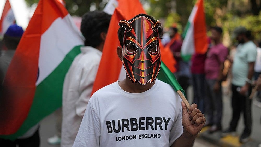 A supporter of the Cockroach Janta Party wears a mask as he takes part in a protest against Chief Election Commissioner Gyanesh Kumar and call for the suspension of the Special Intensive Revision (SIR) of electoral rolls in Mumbai, Friday, Oct. 2, 2026. 
 - | Photo: AP/Rafiq Maqbool