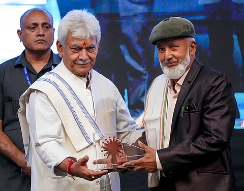 Jammu and Kashmir Lieutenant Governor Manoj Sinha presents a memento to a participant during a commemorative event organized on the occasion of Gandhi Jayanti, at Sher-i-Kashmir International Conference Centre (SKICC), in Srinagar.