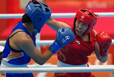 India's Lovlina Borgohain, in blue, and China's Bao Ziyi, in red, fight in their women's 75kg boxing final match at the Asian Games in Nishio, Aichi prefecture, Japan, Friday, Oct. 2, 2026. 
