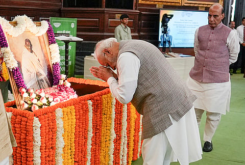 Prime Minister Narendra Modi pays tribute to Mahatma Gandhi on his birth anniversary, at the Central Hall of Samvidhan Sadan, in New Delhi. Defence Minister Rajnath Singh is also seen. 