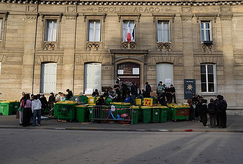 Students block the entrance of the high school Arago as they protest against under-resourced schools in Paris, Friday, Oct. 2, 2026. 
