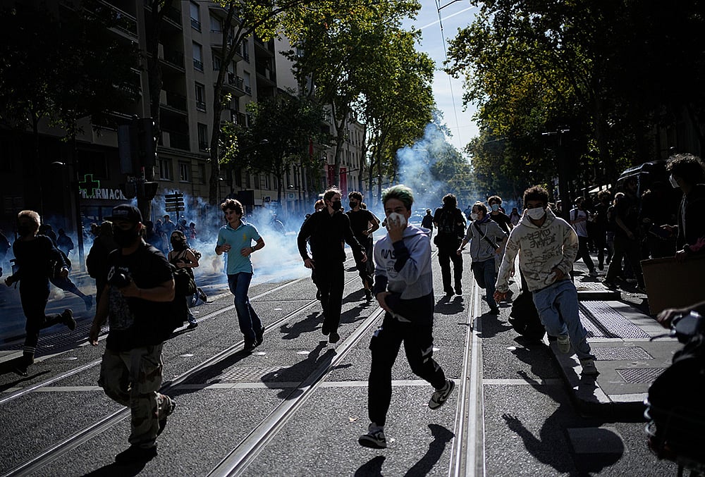 Students run out the teargas during a protest against under-resourced schools in Lyon, France, Friday, Oct. 2, 2026. 
 - | Photo: AP/Laurent Cipriani