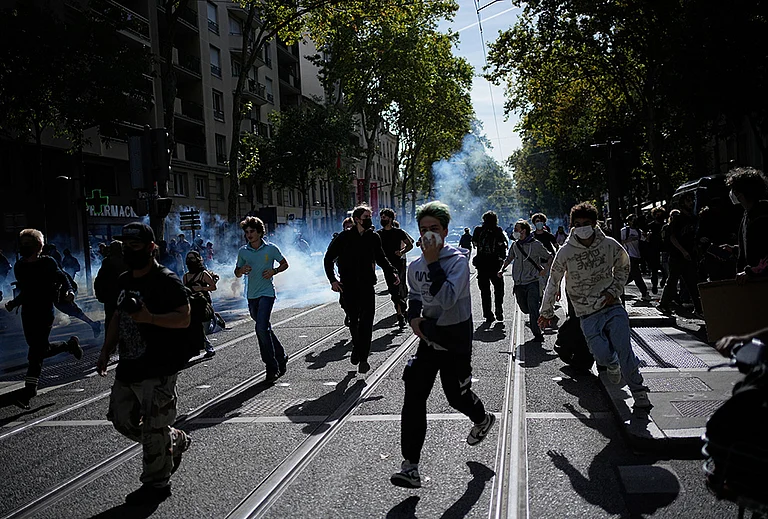 Students run out the teargas during a protest against under-resourced schools in Lyon, France, Friday, Oct. 2, 2026.
- | Photo: AP/Laurent Cipriani