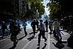 | Photo: AP/Laurent Cipriani : Students run out the teargas during a protest against under-resourced schools in Lyon, France, Friday, Oct. 2, 2026. 
