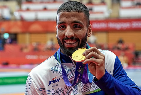 India's Sujeet Kalkal poses for photographs after winning gold medal in the men's Freestyle 65 kilogram final bout 196 wrestling event in the ongoing Asian Games 2026, in Nagoya, Japan, Friday, Oct. 2, 2026. 