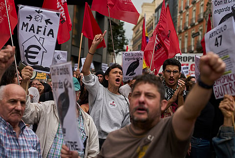 Activists protest near the Spanish Parliament following the eviction of 87-year-old Maricarmen to demand stronger laws to protect renters in Madrid, Spain, Friday, Oct. 2, 2026. 
