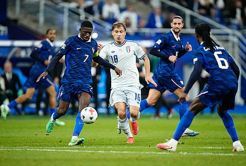 Italy's Nicolo Barella, centre, and France's Ousmane Dembele, left, challenge for the ball during the UEFA Nations League Group A soccer match between France and Italy in Saint-Denis near Paris, Friday, Oct. 2, 2026. 